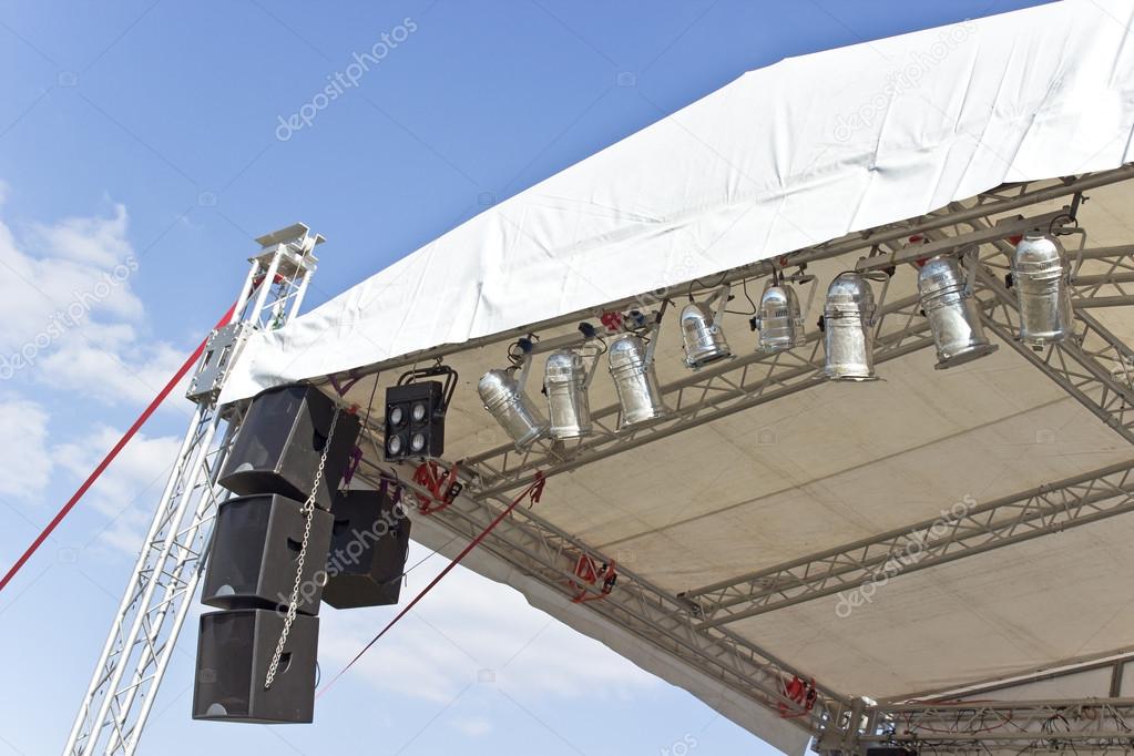Outdoor concert stage roof construction with speakers over sky