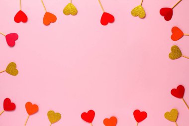 Valentines day background of red and gold hearts on a pink background. Wedding, birthday. Flatlay, copy space