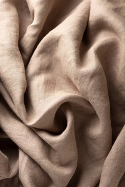 Texture with linen fabric in beige color, selective focus image