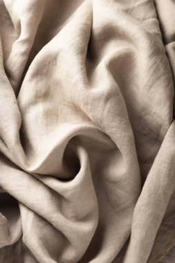 Texture with linen fabric in beige color, selective focus image