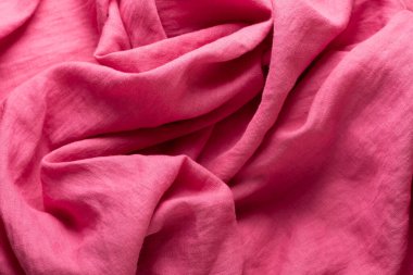 Stonewashed linen fabric in pink color, sewing concept, selective focus image