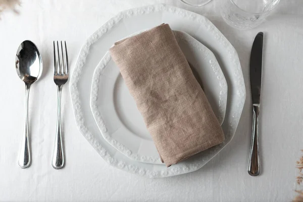 Table decor concept, linen white tablecloth and beige napkin, selective focus image