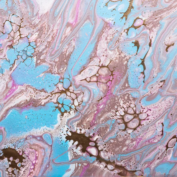 Fluid acrylic painting in pink and gold colors, selective focus image