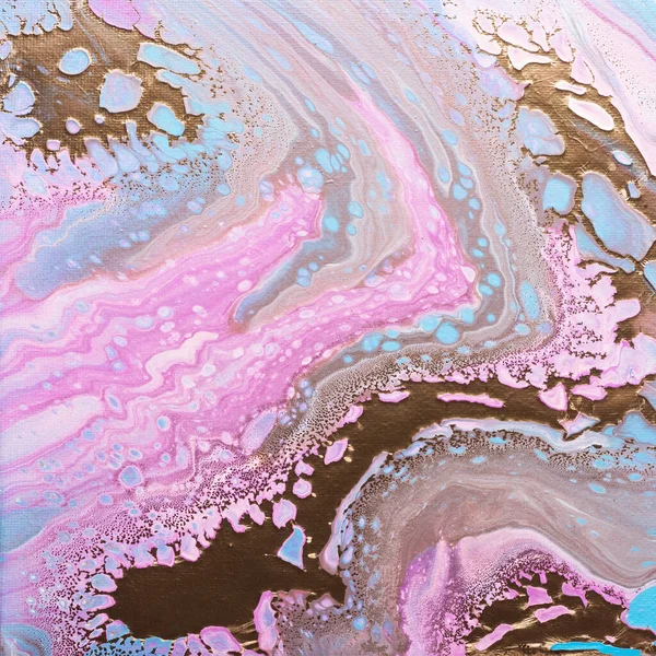 Fluid acrylic painting in pink and gold colors, selective focus image