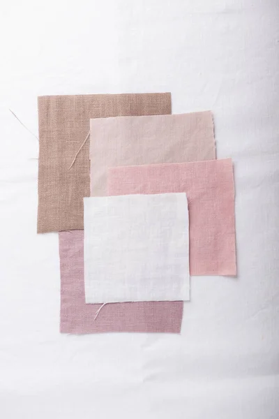 Linen fabric samples in pastel colors, selective focus image