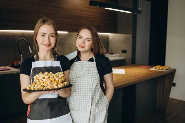 latin woman pastry chef wearing uniform holding a bowl preparing delicious sweets chocolates at kitchen in Mexico Latin America