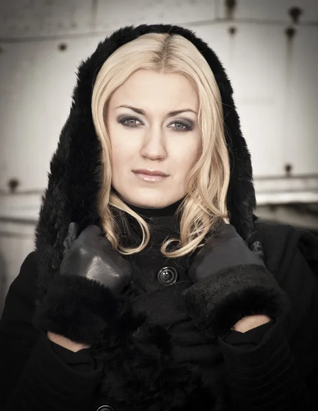 Young woman wearing warm black coat — Stock Photo, Image