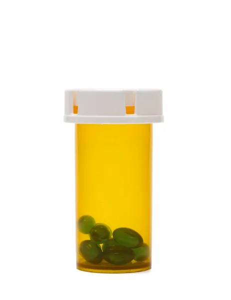 Comprimidos verdes em uma garrafa — Fotografia de Stock