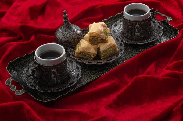 斋月式的招待和阿拉伯式的招待理念 用土耳其面包片和迷你咖啡杯在真正的地中海金属托盘上隔离在红色天鹅绒织物上 — 图库照片