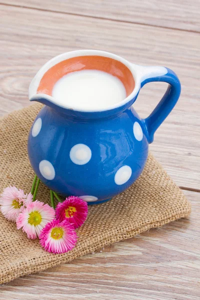 Milk on wooden table — Stock Photo, Image