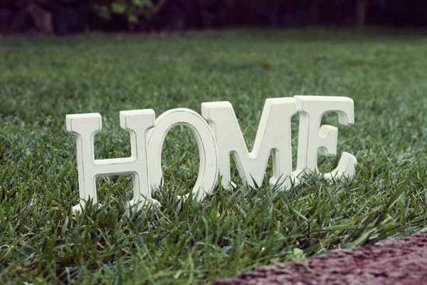 Home sign on grass — Stock Photo, Image