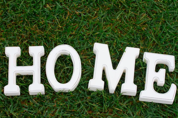 White Home sign on grass — Stock Photo, Image