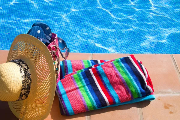 Полотенце и принадлежности для купания возле бассейна — стоковое фото