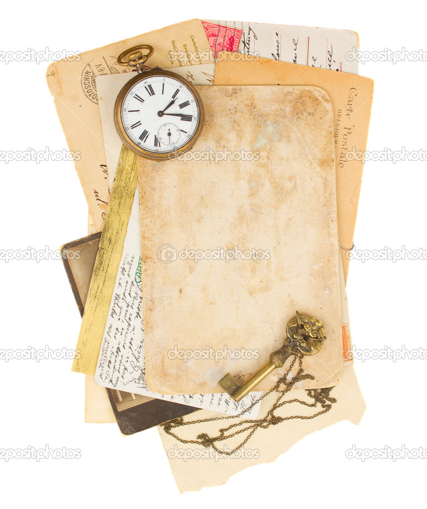 Pile of old photos and papers with antique clock