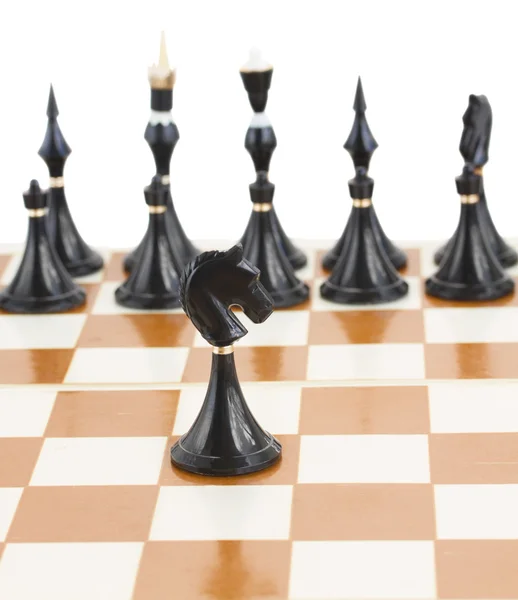 Black knight in front of black chess — Stock Photo, Image