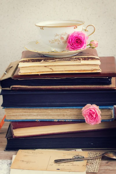 Pile of old books and mail with cup of tea — Stock Photo, Image