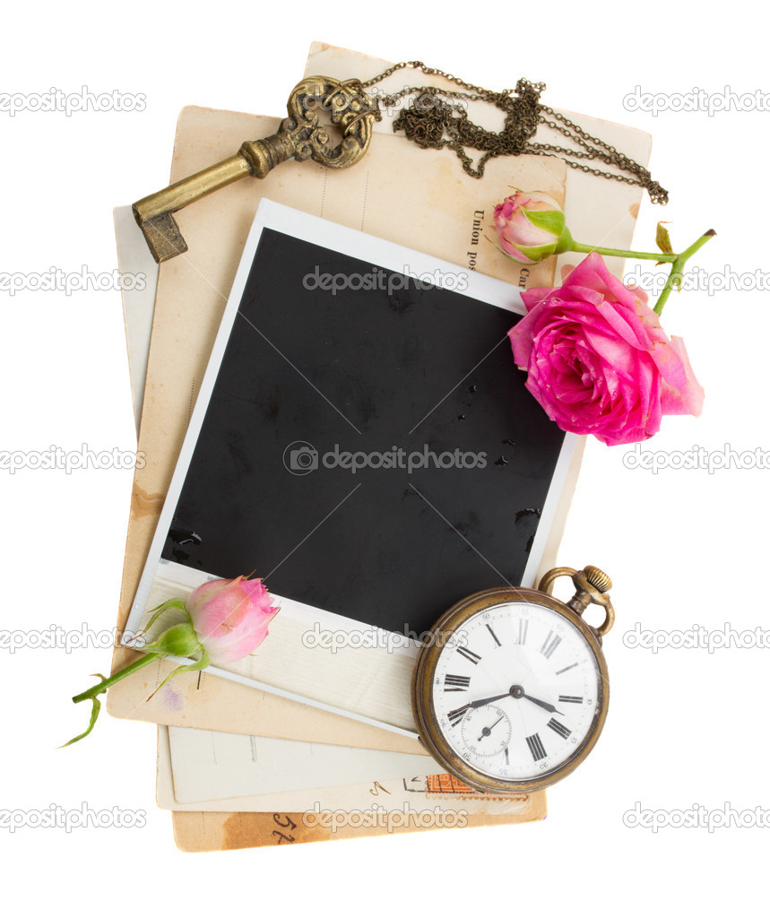 Pile of old photos  with antique clock, key and roses