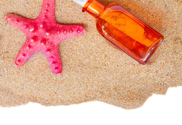 Starfish and bottle with letter on sand — Stock Photo, Image