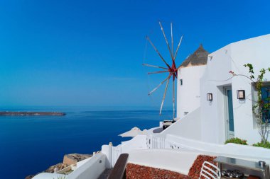 Beyaz yel değirmenli geleneksel manzara, Yunanistan 'ın Santorini kentindeki beyaz Yunan köyü