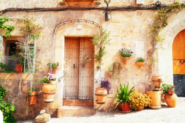 wall with traditional flower pots in old town of Valdemossa, Majorca, Spain, toned clipart