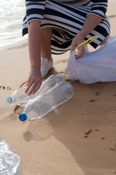 cleaning plastic on the beach.