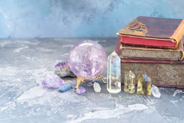 Gemstone rahatlama ve meditasyon için hazır. Sihirli top ve Reiki için yarı başkanlık mineralleri arka planda kitaplar, iyileştirici kristal ritüeller, cadılık, ruhsal esrarengiz uygulamalar.