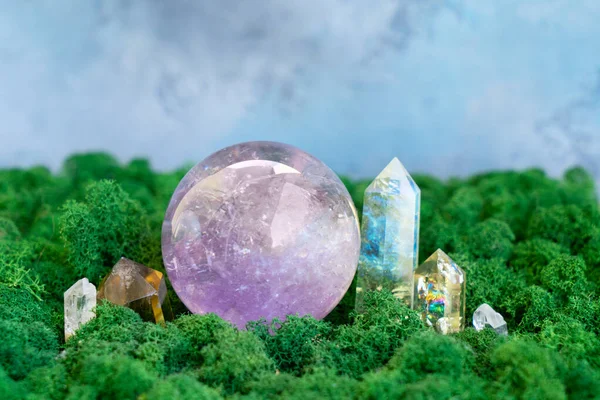 gemstones minerals and crystal ball on mysterious natural forest moss background, crystals top view . Magic healing Rock for Reiki Crystal Ritual, Witchcraft, spiritual esoteric practice