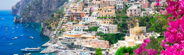 view of Positano town at summer - old italian resort with flowers, Italy, web banner