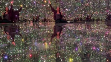 Talented Innovative woman plays with an interactive virtual light installation. New art form, generative graphics. Woman plays in augmented virtual reality