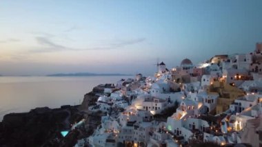 Establishing shot of famous sunset near Oia village, Santorini Greece