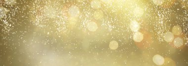 Koyu altın ve gümüş arkaplan. Parlak parıltılar ve ışıklar, web pankartı biçimi.