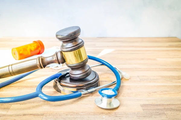 law gavel with sthetoscope, masks and pills, medical responsibility law concept