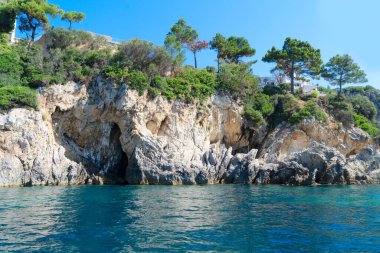 Paleokastritsa blue caves, pines and Ionian sea on Korfu, Greece