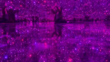 Talented Innovative woman plays with an interactive virtual light installation. New art form, generative graphics. Woman plays in augmented virtual reality