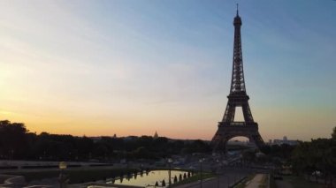 Paris Eiffel Tower at Trocadero gardens at sunrise in Paris, France. Eiffel Tower is one of the most iconic landmarks of Paris with sunshine