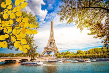 Paris famous landmarks. Eiffel Tower with yellow tree over river at fall, Paris France