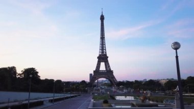 Paris Eiffel Tower at Trocadero gardens at sunrise in Paris, France. Eiffel Tower is one of the most iconic landmarks of Paris with sunshine