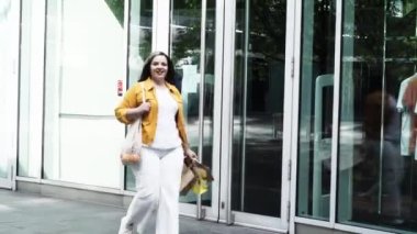 Happy curvy woman with ecologic craft shopping bags enjoying in shopping. Consumerism, shopping, lifestyle concept