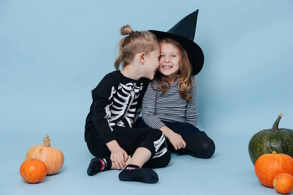 Siblings in halloween costumes touching heads and laughing. — Stock Photo, Image