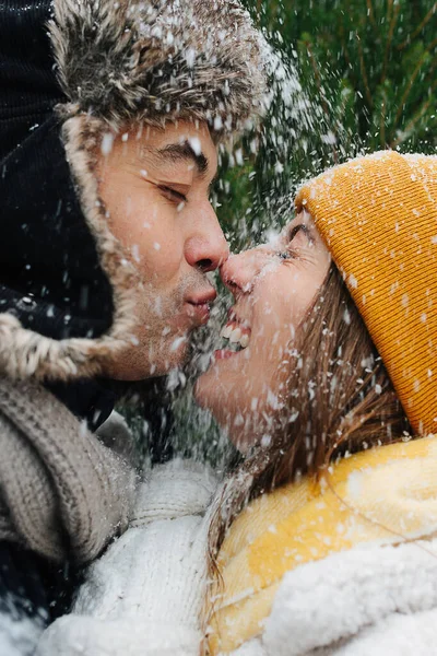 Emotional portrait, close-up faces, couple kissing snow is falling on them — Stock Photo, Image