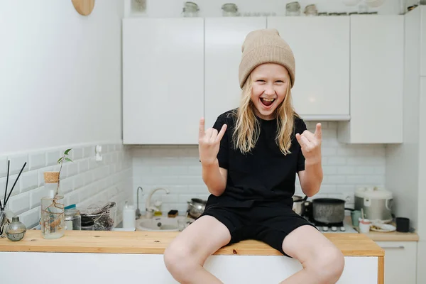 Hyped Pumped Boy Sitting High Bar Table Kitchen Showing Rock — Stock Photo, Image