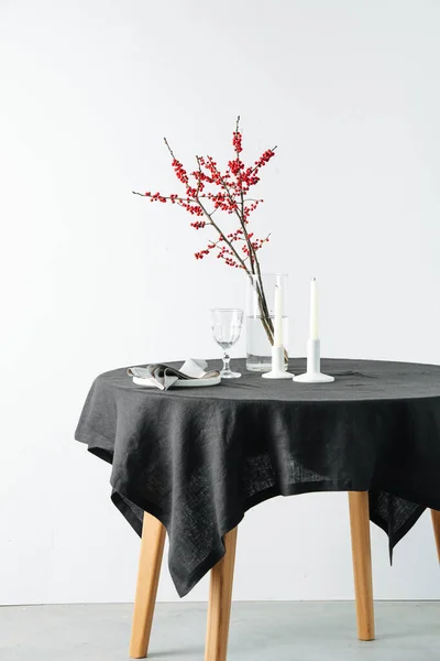 Rowan branch, tableware on a round table with a black rough tablecloth — Stock Photo, Image