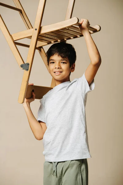 Ordinary Indian Boy Playing Wooden Folding Chair Beige Room Holding Stock Photo