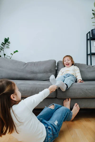 Strong Girl Making Physical Effort Pulling Sock Boy Preparing Tickling — Stock Photo, Image