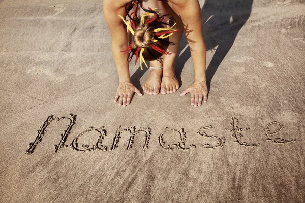 Yoga on the beach with Namaste — Stock Photo, Image