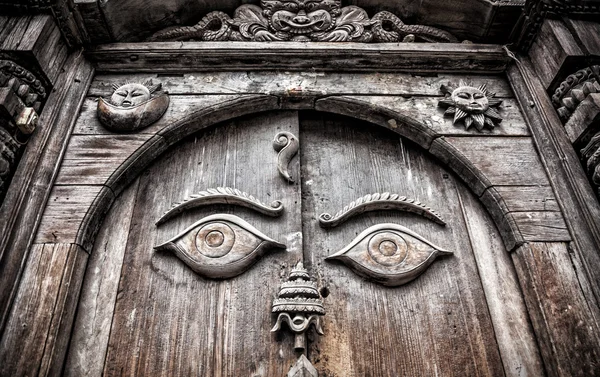 Wooden door with eyes — Stock Photo, Image