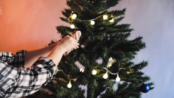 Οικογενειακό ζευγάρι στολίζει χριστουγεννιάτικο δέντρο με παιχνίδια — Αρχείο Βίντεο