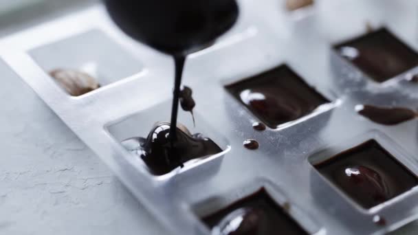 Woman make homemade chocolate candy with nuts — Video