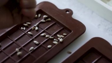 Woman make homemade chocolate candy with nuts