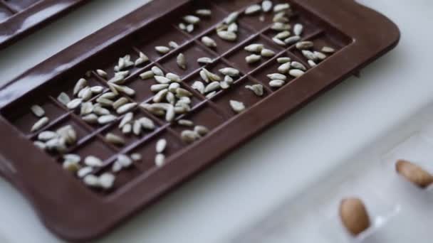 Woman make homemade chocolate candy with nuts — Stock video